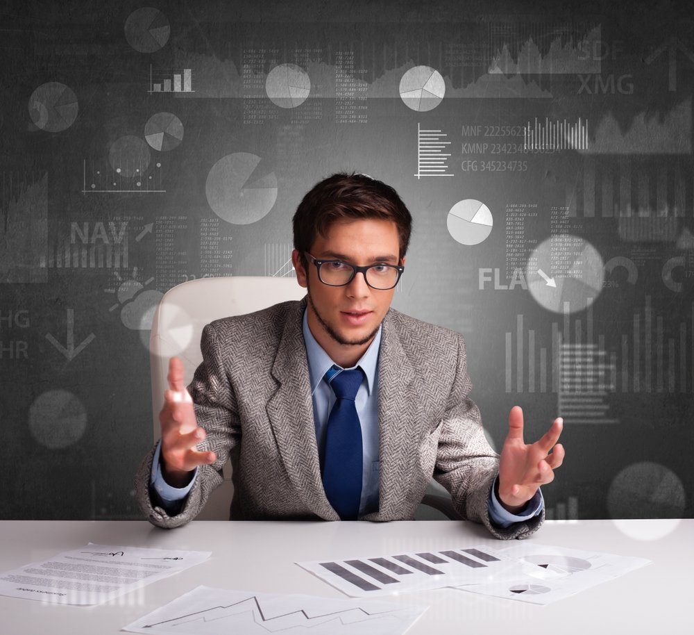 Young manager at the office making report and statistics with blackboard background